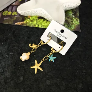 Gold stainless steel marine theme dangle earrings with turtle and starfish charms for women.