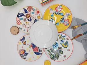 Hand-painted ceramic dinner plate detail, artistic floral and animal patterns for table setting.