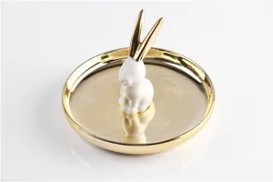 Golden ceramic rabbit ring dish detail view, elegant jewelry organizer for desktop.