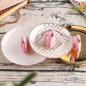Nordic ceramic flamingo jewelry tray with gold trim, perfect for rings and accessories.