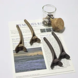 Matte duckbill hair clips detail view, stylish brown hair pins for daily styling and makeup.