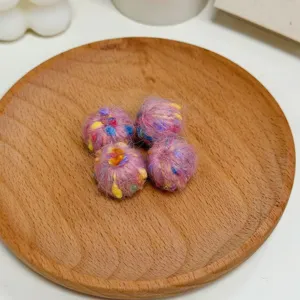 Close-up detail shot of colorful DIY knitted yarn balls, perfect for handmade jewelry accessories.