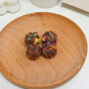 Closeup of colorful dotted yarn balls for DIY jewelry making and handmade crafts detail shot