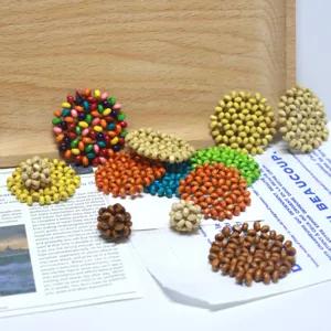 Close-up of handmade wooden beaded balls, colorful DIY jewelry pendant accessories display.
