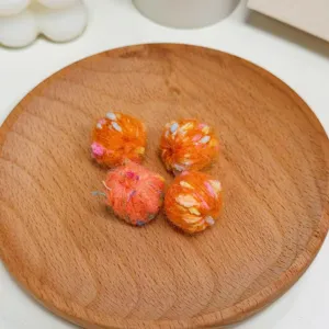 Close-up of colorful dot wool yarn balls, knitted straight hole DIY jewelry accessories beads.