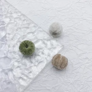 Close-up detail view of colorful fuzzy plush ball charms for DIY jewelry making accessories.
