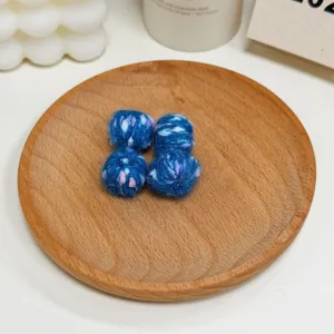 Blue multi-colored speckled wool yarn balls, DIY handmade knitted jewelry accessories.