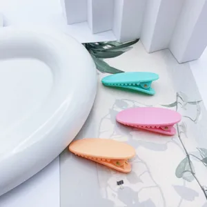 Detail view of three colorful pastel oval duckbill hair clips, cute hair accessories for daily.