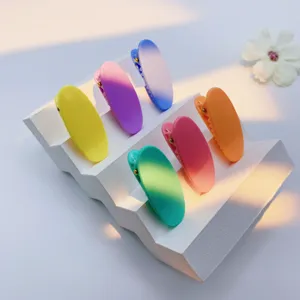 Detail view of colorful candy duckbill hair clips arranged neatly on a white display stand.