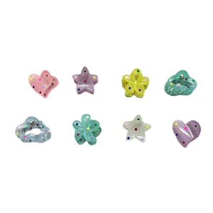 Mini translucent hair claw clips set featuring cute heart star and flower designs with colorful dots.