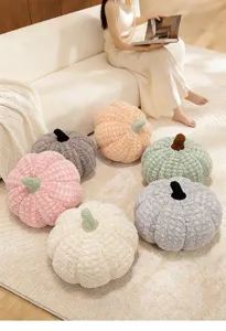 Soft plush pumpkin pillow detail shot, cozy home sofa decor, cute stuffed cushion toy.