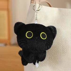 Cute black cat plush keychain hanging detail, soft material with embroidered eyes for bag.