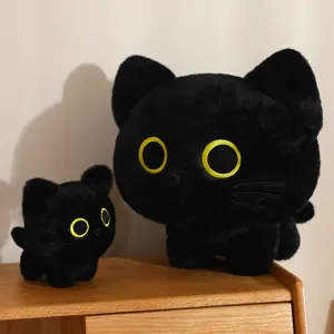 Close-up detail of cute black cat plush toy, showing soft stuffed doll texture and eyes.