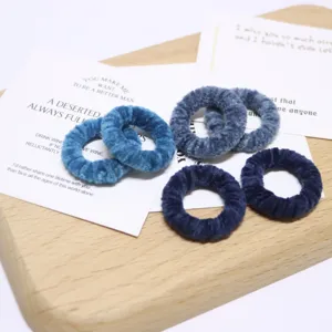 Blue velvet hair scrunchies detail view, soft autumn winter hair ties and accessories.