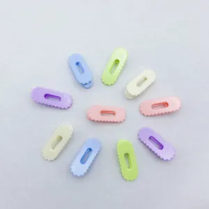 Closeup detail shot of colorful wavy oval hair clips set, cute candy color accessories for women.