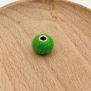 Green plush felt bead with metal eyelet charm spacer for handmade phone charms and jewelry.