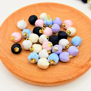 Close-up of colorful fabric wrapped round beads on wood tray, detail view of DIY parts.