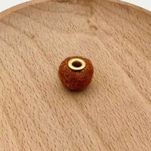 Brown plush metal hole bead detail shot, ideal for handmade phone straps and jewelry.