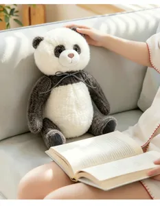 Knitted panda plush toy detail view, sitting cute panda doll with cozy sofa and book scene.