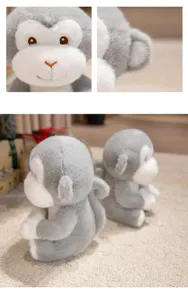 Cute gray white plush monkey toy detail close up of soft face and sitting doll design.