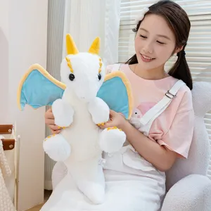 Detailed shot of the cute white fantasy dragon plush toy with blue wings and soft fabric.