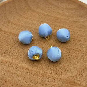 Light blue fabric covered buttons DIY clothing accessories handmade sewing craft supply detail