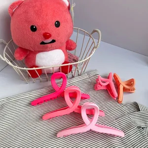 Matte cross hair claw clips in macaron pink, perfect for styling bangs and updos easily.