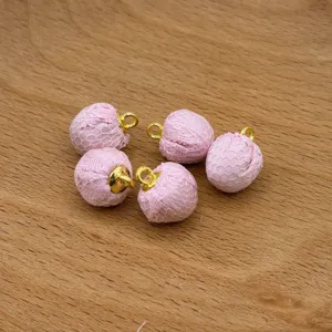 Pink mesh fabric covered charms, close-up details for DIY jewelry making accessories.