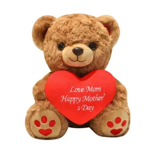 Cute brown teddy bear plush toy holding red heart for kids and girls, soft doll gift.