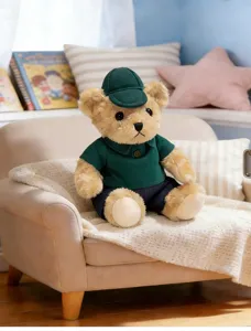 Adorable plush teddy bear doll sitting on mini sofa in cozy room scene detail.