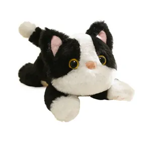 Cute black and white plush cat toy fridge magnet, soft stuffed animal doll for decor.