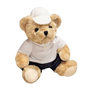 Cute plush teddy bear toy sitting down wearing a white polo shirt and cap for kids and gifts.