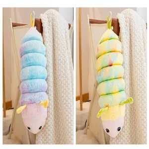 Detailed close-up of cute colorful tie-dye caterpillar plush toy hanging in cozy home decor.