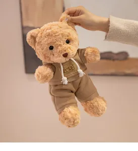 Cute teddy bear plush toy wearing a brown hoodie, soft and cuddly stuffed animal doll for kids.