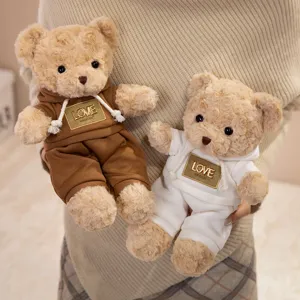 Cute plush teddy bear toy holding soft stuffed animal doll with hoodie clothing for kids.