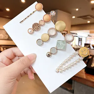 Set of delicate handmade alloy hair clips and side barrettes with pearls and rhinestones.