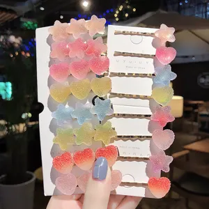 Details of colorful glitter star and heart hair clips on white display cards for daily wear.