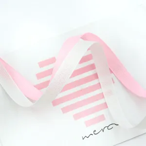 Glitter grosgrain ribbon detail shot, pink and white fabric ribbon for DIY bows and gift wrapping.