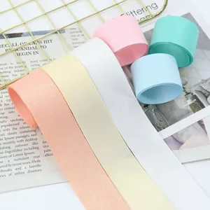 Glitter grosgrain ribbon detail view, pastel color rolls and strips for gift wrapping & DIY.