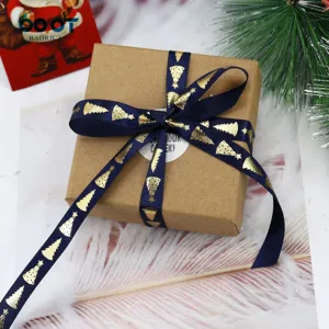 Blue Christmas ribbon with gold trees pattern for gift wrapping and holiday decoration.