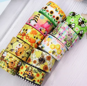 38mm heat transfer ribbon rolls with cute bee sunflower gnome prints for DIY crafts and decor.