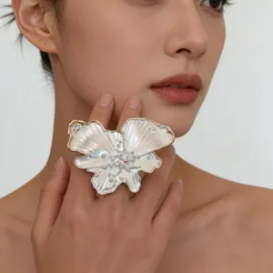 Close-up detail of luxury pearlescent glazed butterfly ring, artistic avant-garde jewelry.