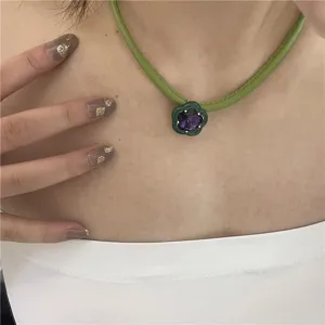 Green PU leather choker with purple crystal flower pendant, stylish collar jewelry for women.
