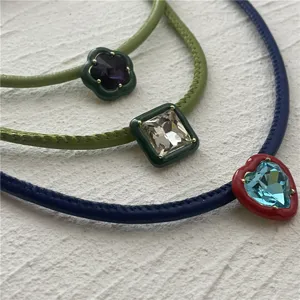 Candy color PU leather choker necklace with geometric crystal flower and heart pendants.