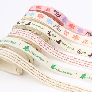 Cotton linen ribbon rolls with printed holiday patterns and text for DIY crafts and gift wrapping.