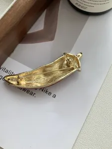 Detailed back view of the red enamel chili pepper brooch showing secure pin clasp design.