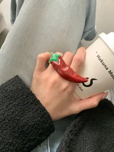Chili ring detail view, red enamel finger jewelry, sweet cool dopamine fashion accessory.