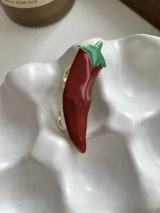 Red chili pepper enamel ring detail, gold rim sweet cool dopamine fashion jewelry piece.