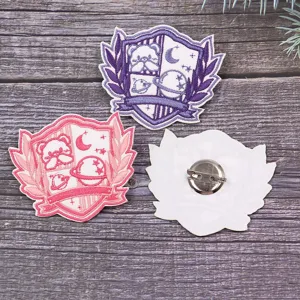 Close-up detail of cute JK uniform embroidered shield brooch badge back and front display.