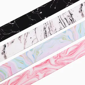 Close up detail of 25mm marble print double sided ribbon fabric texture and pattern design.